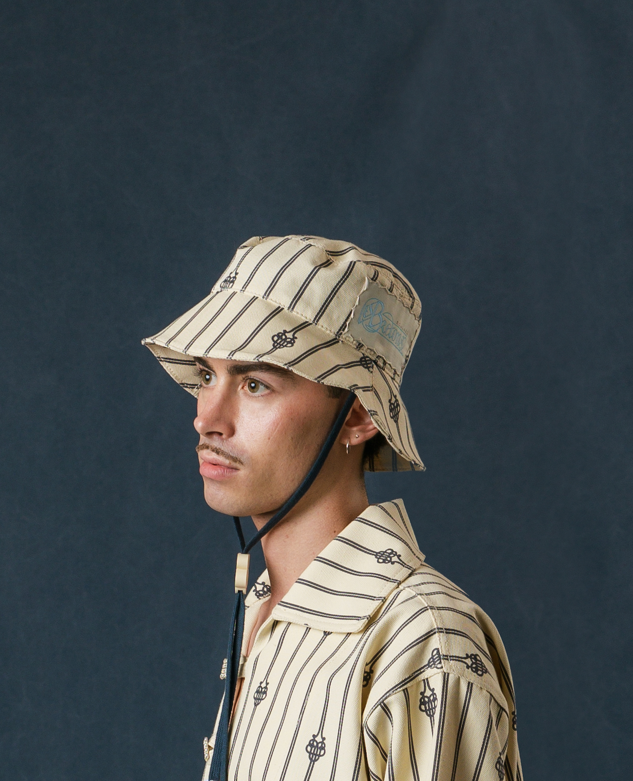 UB MONOGRAM SHORT ROPE BUCKET HAT